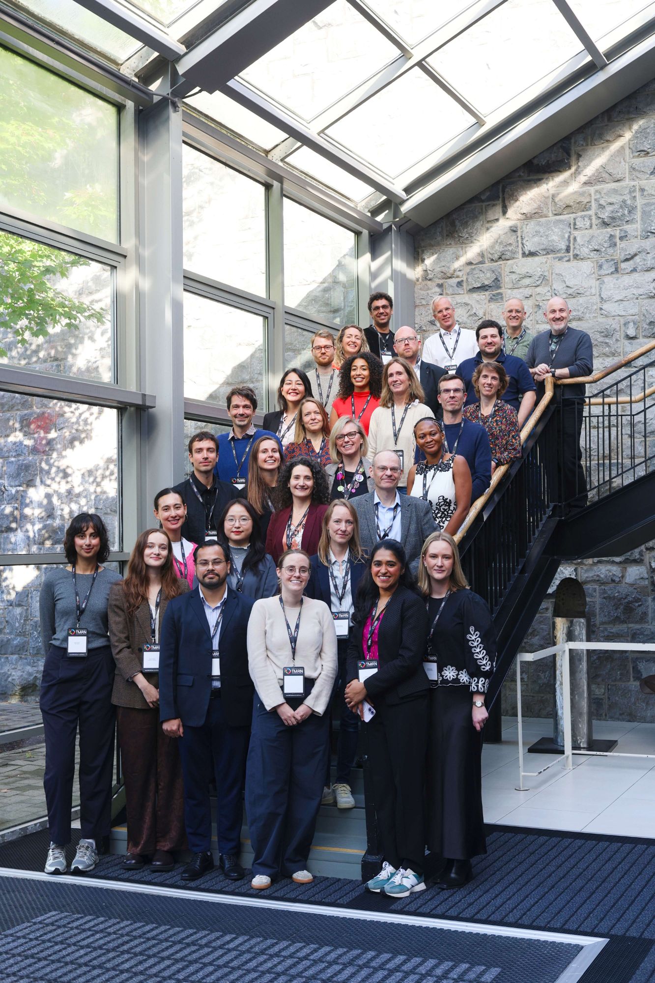 Group photo of EDICT doctoral candidates and supervisors on a staircase at the Kick-Off Training Event